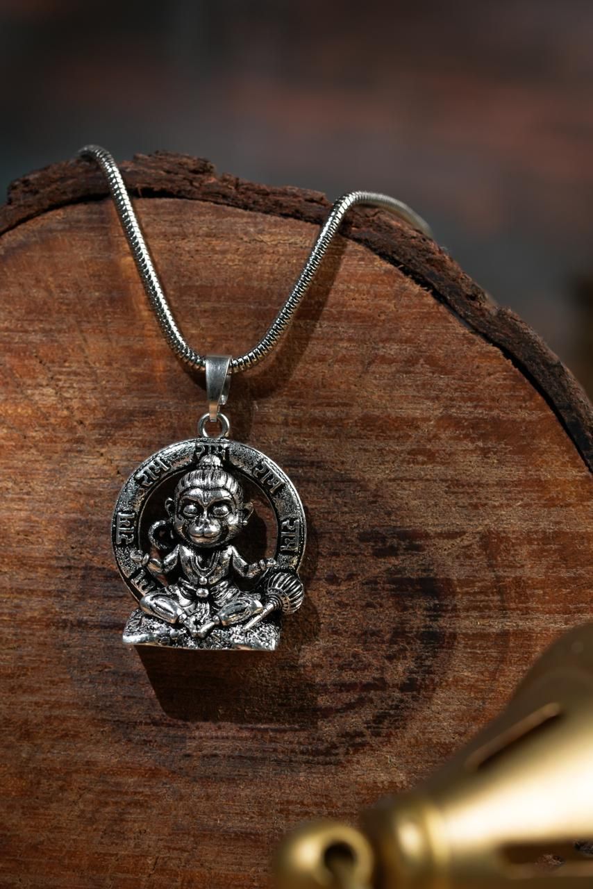 a silver-colored Lord Bal Hanuman pendant on a chain