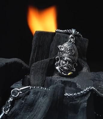 A silver stainless steel pendant in the shape of a Lord Shyam maharaj figure, displayed with a chain