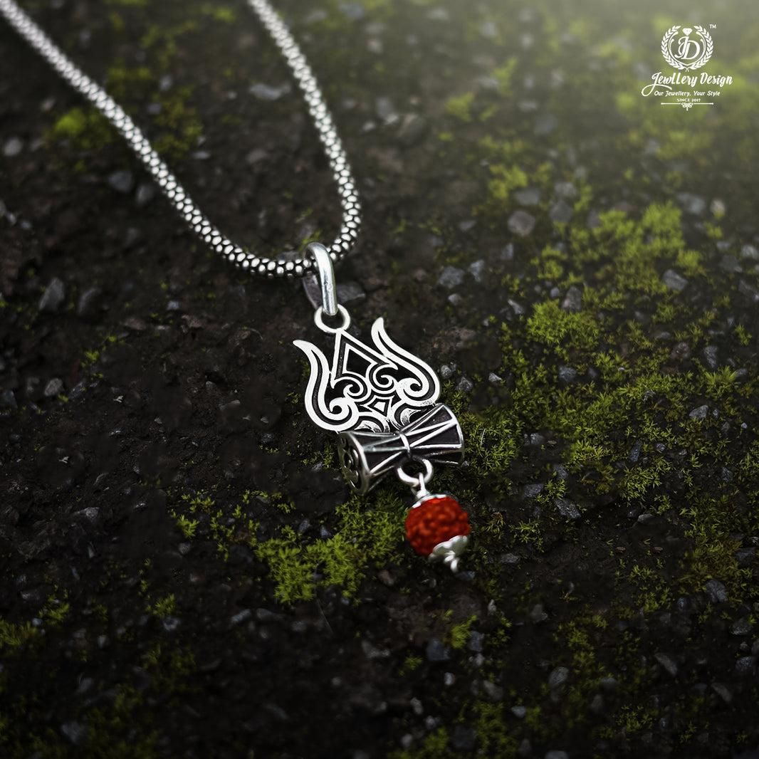 A silver oxidised Trishul Damru Rudraksha pendant chain with a small red bead on the pendant