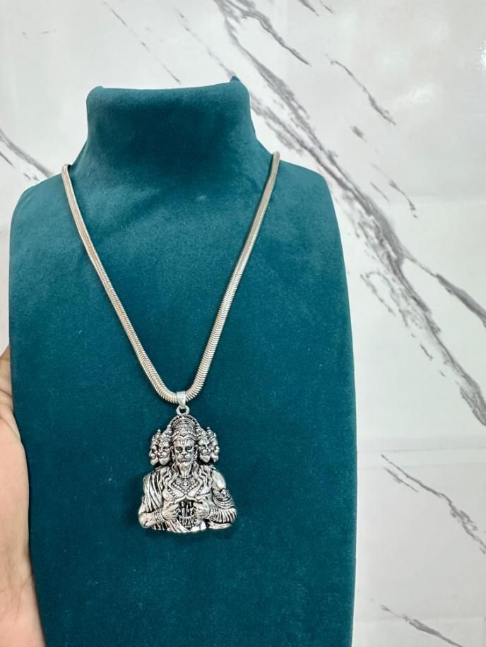 A silver-colored Panchamukhi Hanuman pendant attached to a snake chain