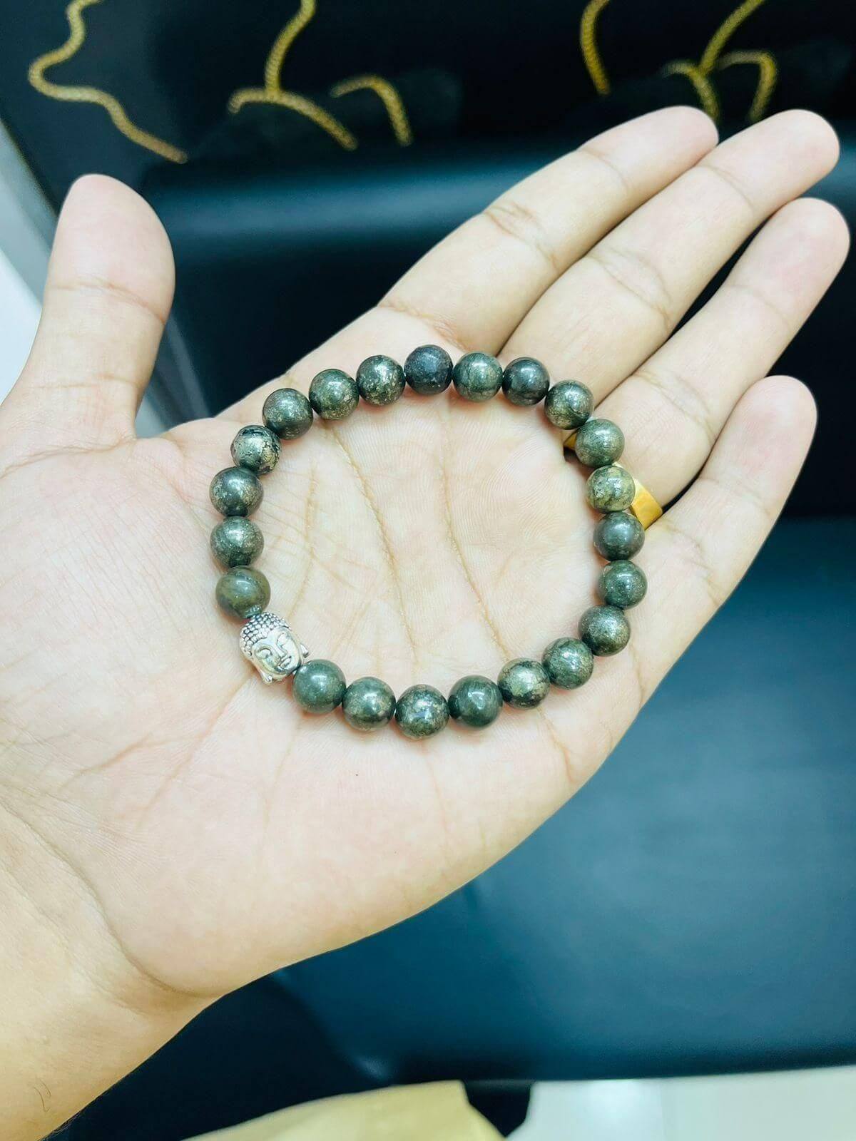 Bracelet with pyrite beads and a silver Buddha charm