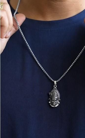 A silver stainless steel pendant in the shape of a Lord Shyam maharaj figure, displayed with a chain