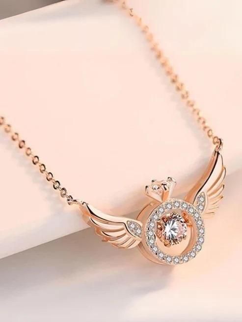 Rose gold colored pendant chain featuring angel wings design with a central crystal embellishment.
