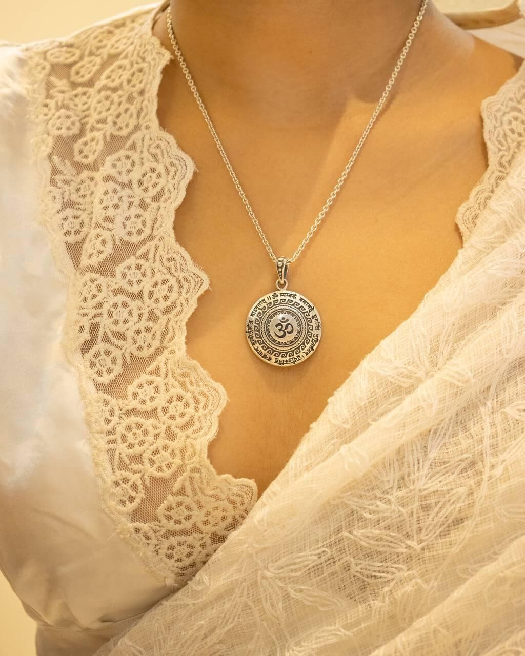 silver pendant with an Om symbol