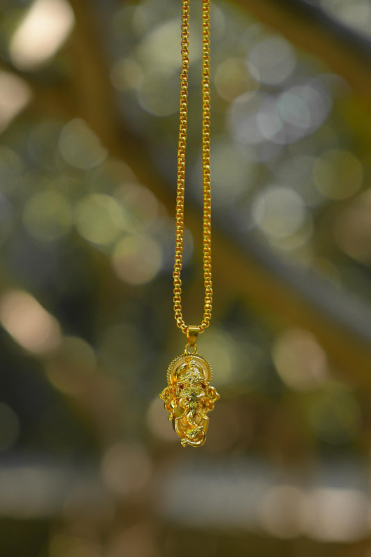 A gold-colored Ganesha pendant attached to a snake chain
