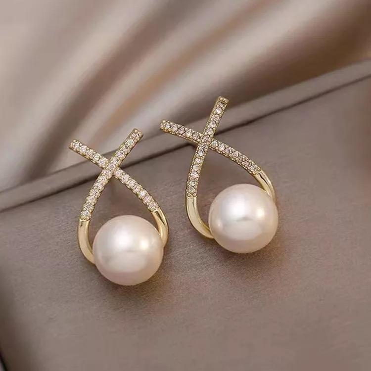 A pair of gold and silver platted cross pearl stud earrings with multicolor stones