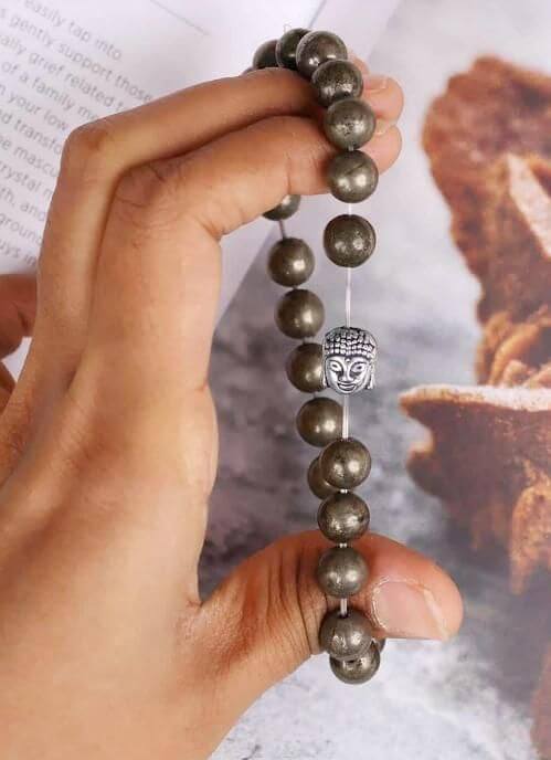 Bracelet with pyrite beads and a silver Buddha charm