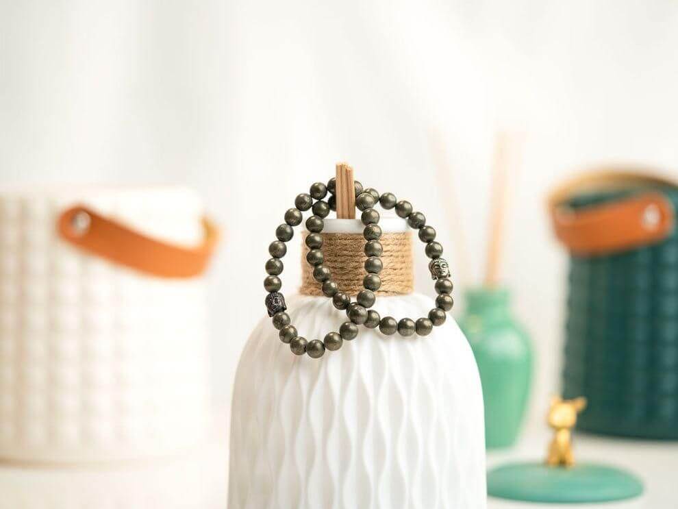 Bracelet with pyrite beads and a silver Buddha charm