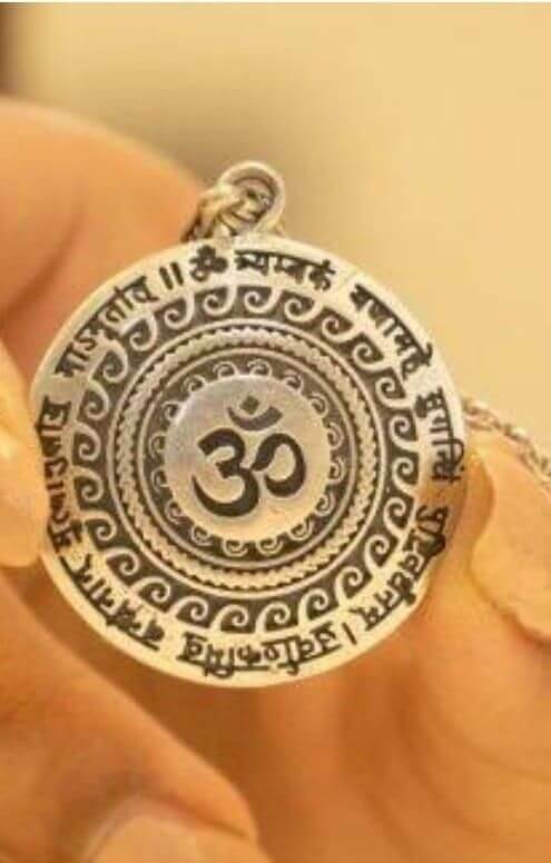 silver pendant with an Om symbol