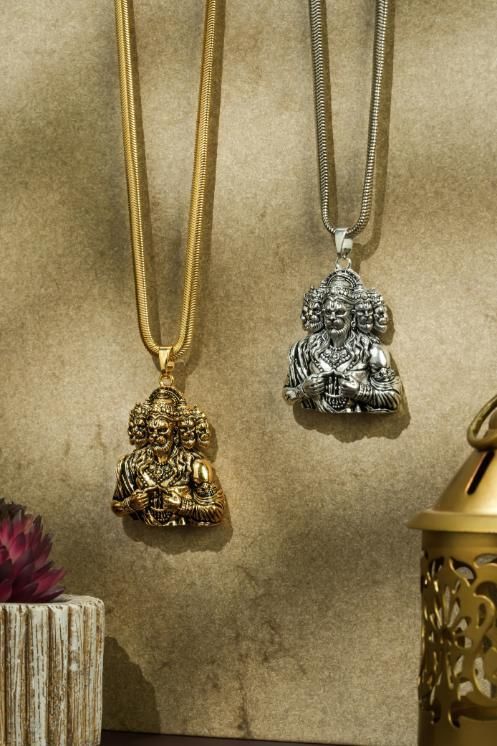 A golden-colored pendant featuring Panchamukhi Hanuman seated in a meditation pose, attached to a golden snake chain